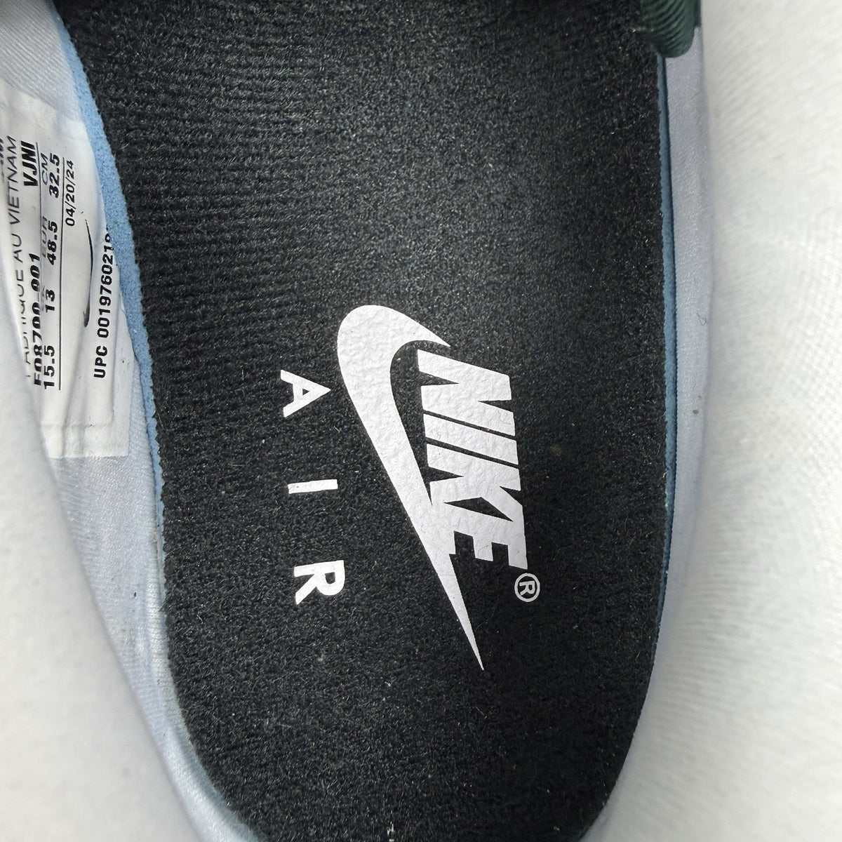 Nike Air Max 1 trainers green with white and silver accents, featuring iconic logo.