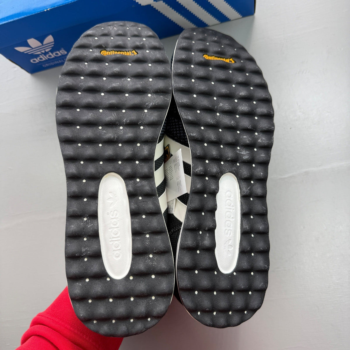 Adidas black deck shoes with white stripes and logo, brand new in box.