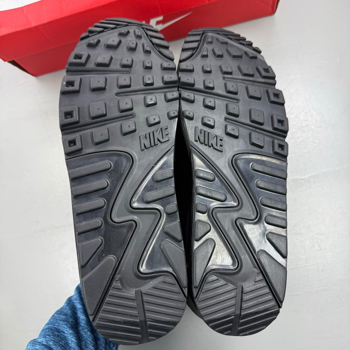 Nike black deck shoes with Air Max cushioning and sleek design.