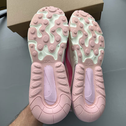 Nike Air Max 270 React white trainers with pink accents and logo detail.