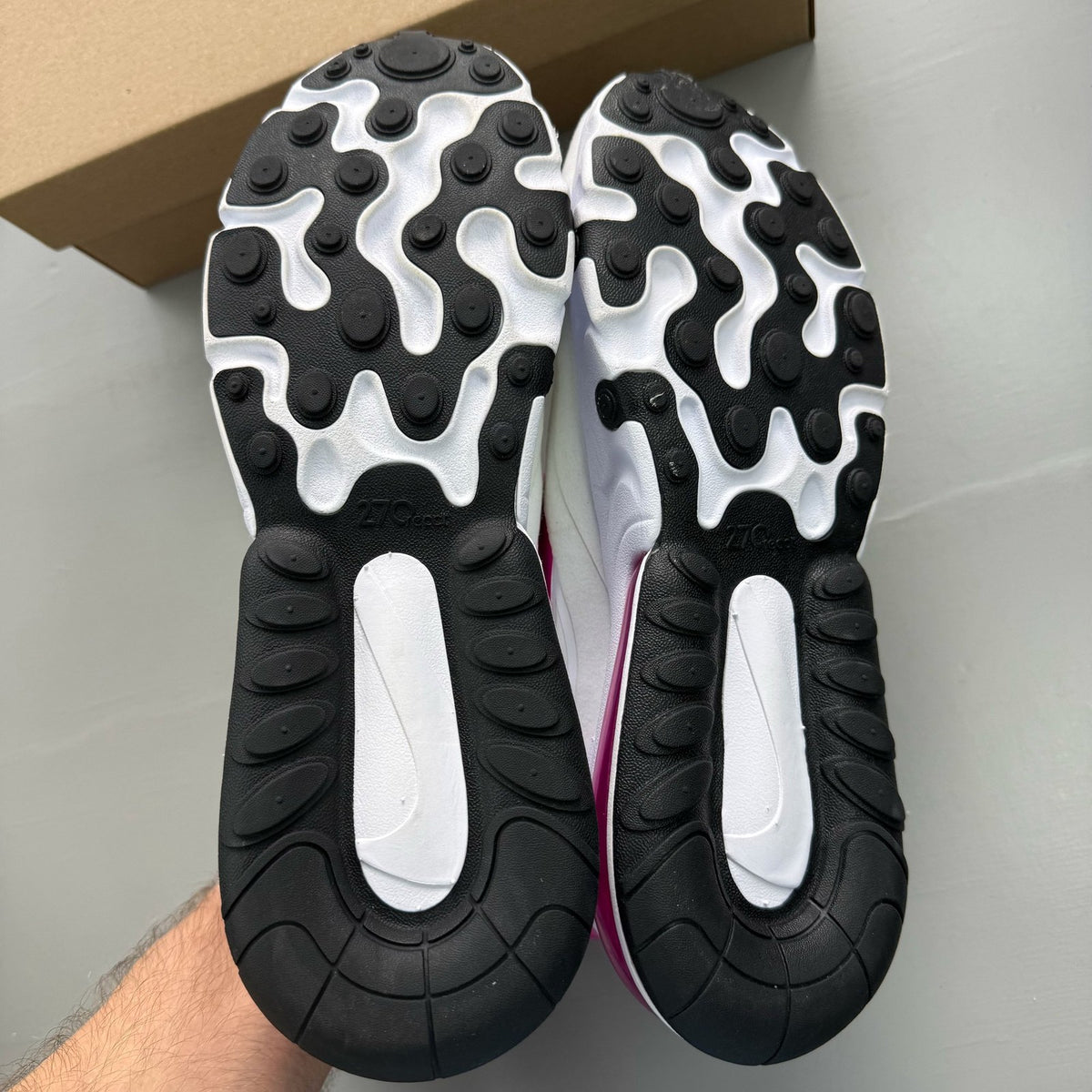 Nike white trainers with fire pink accents and Air Max logo detail.