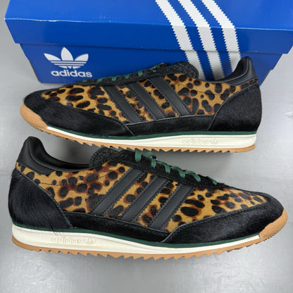 Adidas black trainers with leopard print accents and classic three-stripe logo.