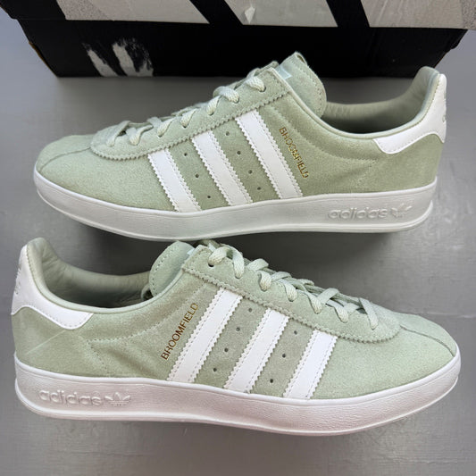 Adidas green deck shoes with white accents and classic logo detailing.