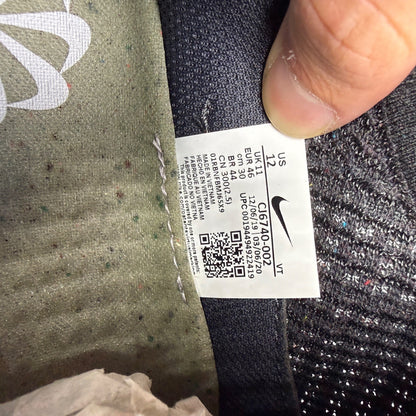 Nike black trainers Flyknit upper with grey accents and Air Max cushioning.