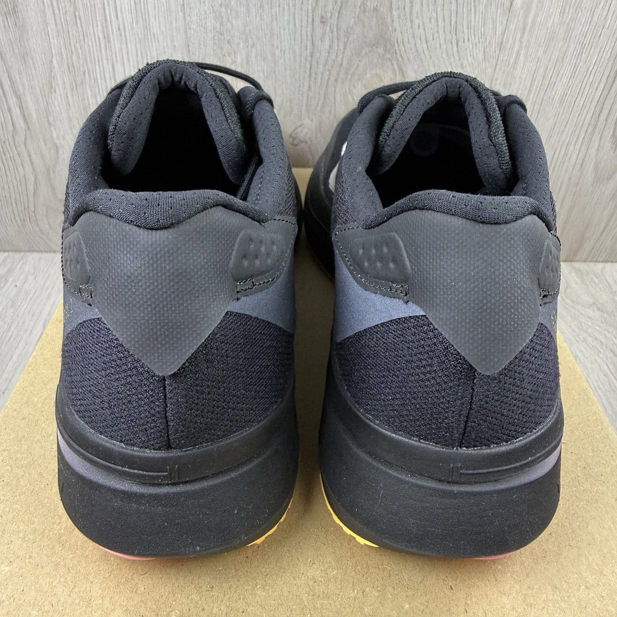 Adidas black trainers with white accents and distinctive Adizero branding.