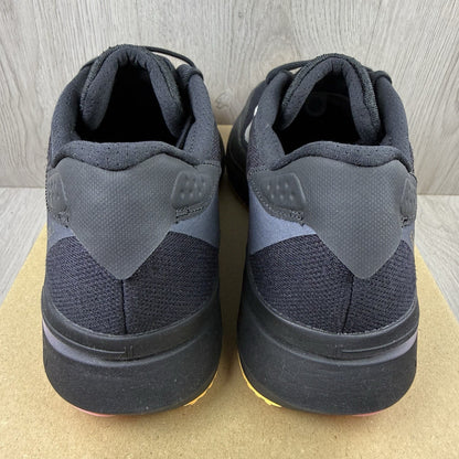 Adidas black trainers with white accents and distinctive Adizero branding.