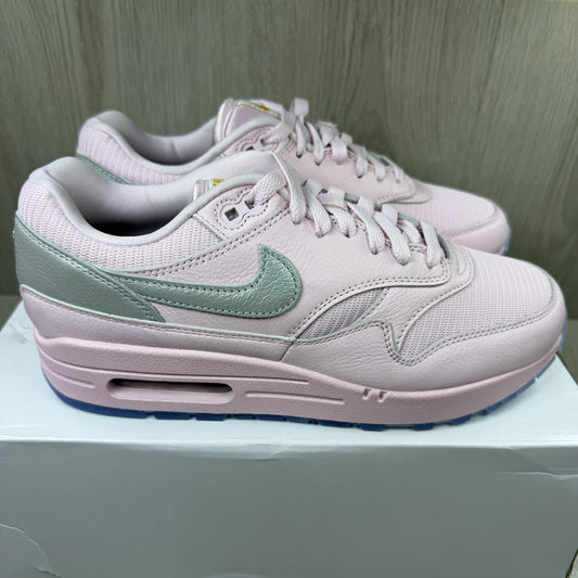 Nike Air Max 1 trainers pink with silver accents and unique design details.