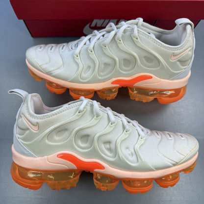 Nike Air VaporMax Plus beige trainers with Phantom Orange accents and distinctive logo.