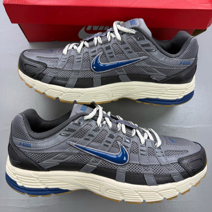 Nike grey blue trainers with pencil point design and logo detail.