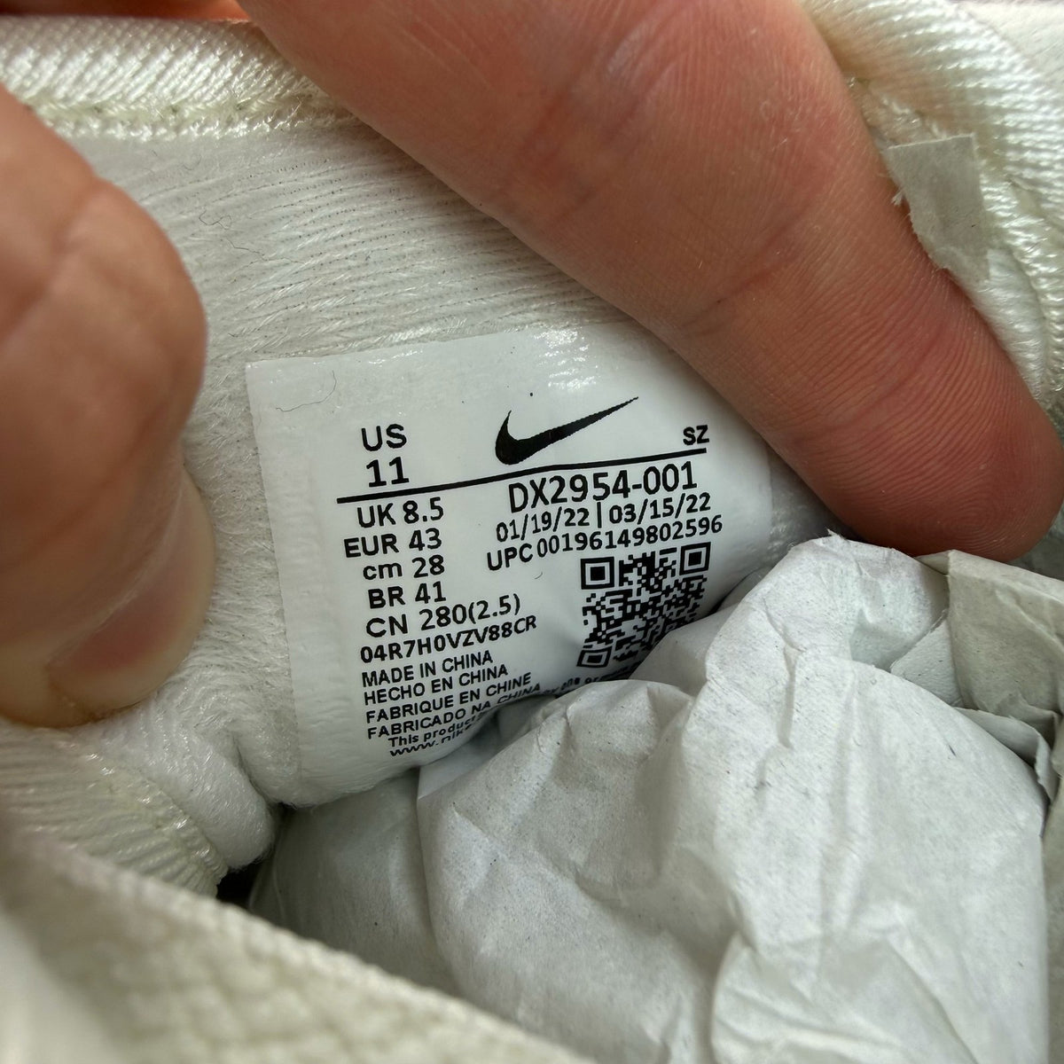 Nike Air Max 1 white trainers with tour yellow accents and logo detail.