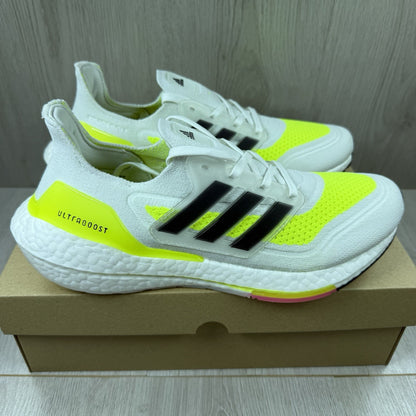 Adidas Ultra Boost 21 white trainers with solar yellow accents and signature three-stripe logo.
