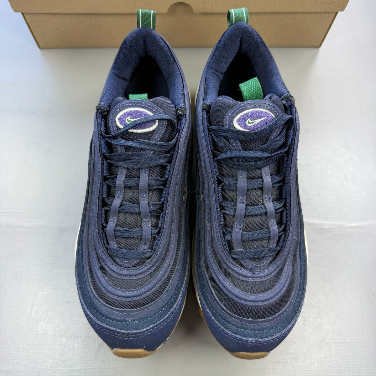 Nike Air Max 97 trainers blue with obsidian navy accents and signature swoosh logo.
