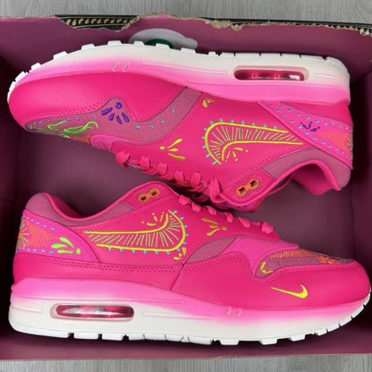 Nike Air Max 1 PRM trainers pink with Día De Muertos pattern and white accents.
