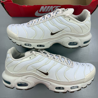 Nike Air Max Plus TN white trainers with signature logo and textured detailing.