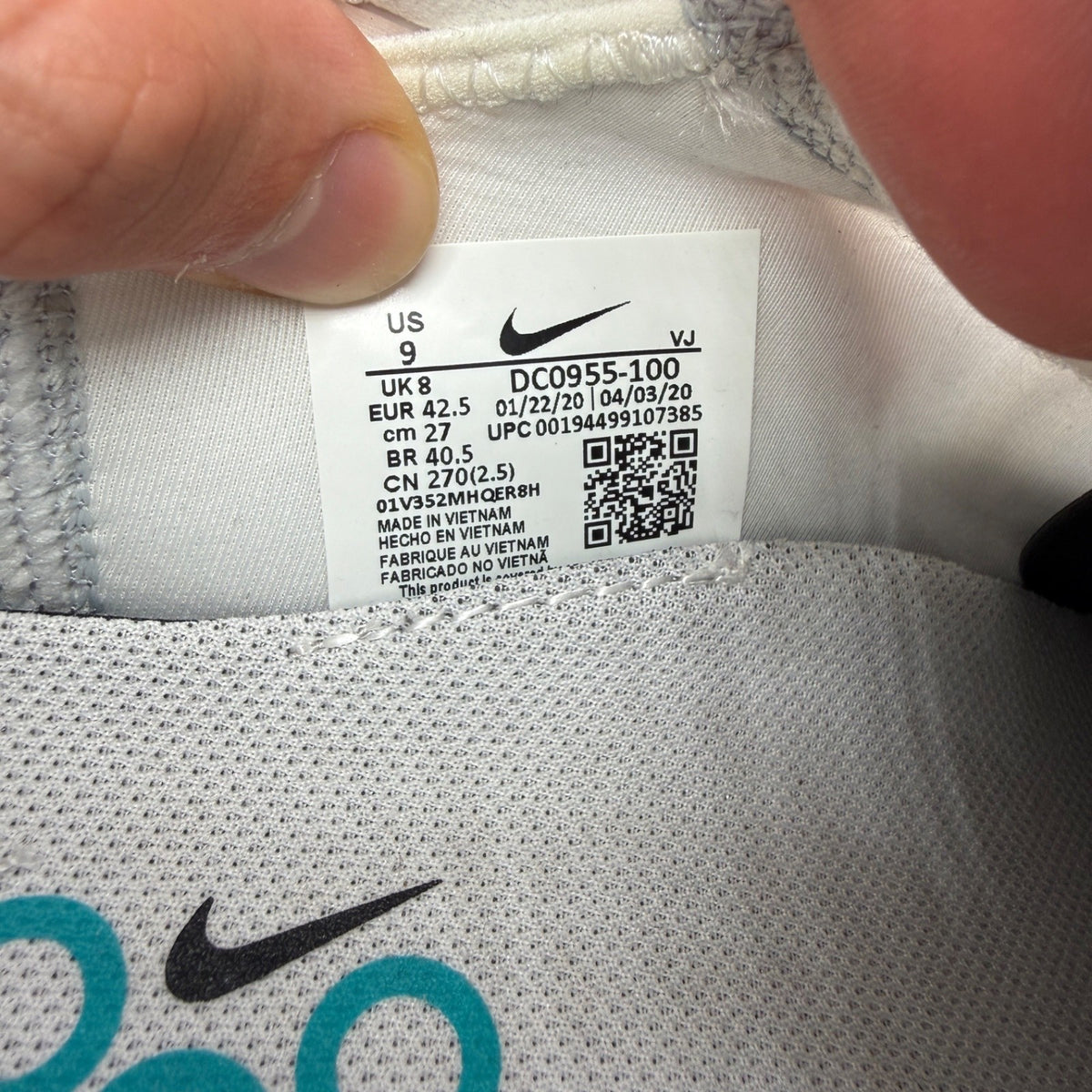 Nike trainers white with black and blue accents, featuring Air Max cushioning and logo.