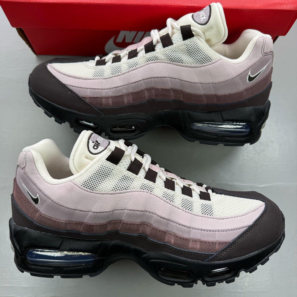 Nike Air Max 95 black trainers with light velvet brown accents and logo detail.