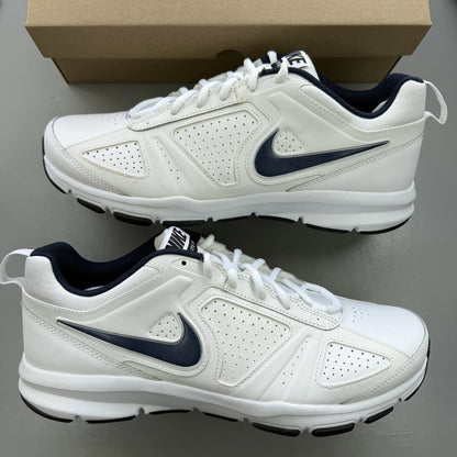 Nike white trainers with navy and black accents, featuring logo detailing and mesh material.