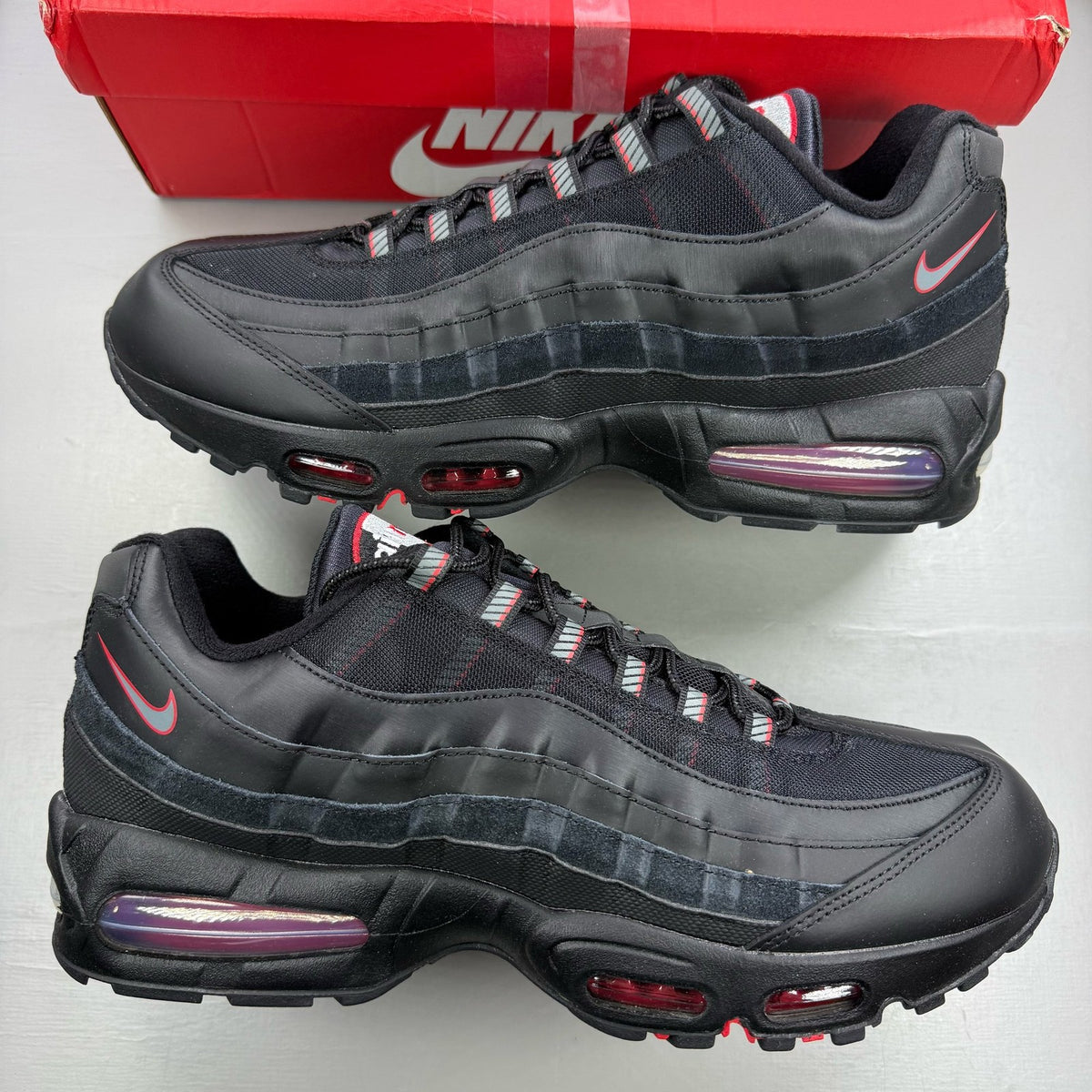 Nike Air Max 95 black sneaker with university red accents and big bubble sole design.