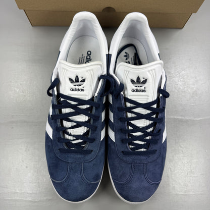 Adidas blue suede trainers with white stripes and logo detailing.