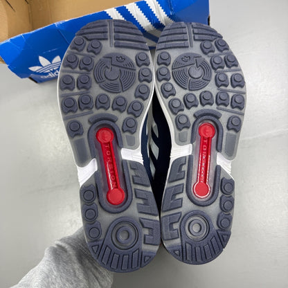 Adidas blue athletic shoes with white accents and ZX Flux logo details.