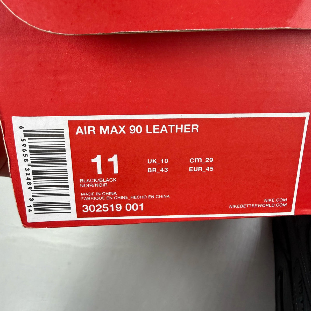 Nike black trainers leather upper with Air Max cushioning and logo detail.