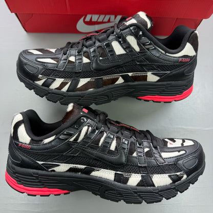 Nike black trainers zebra print design with solar red accents and white detailing.