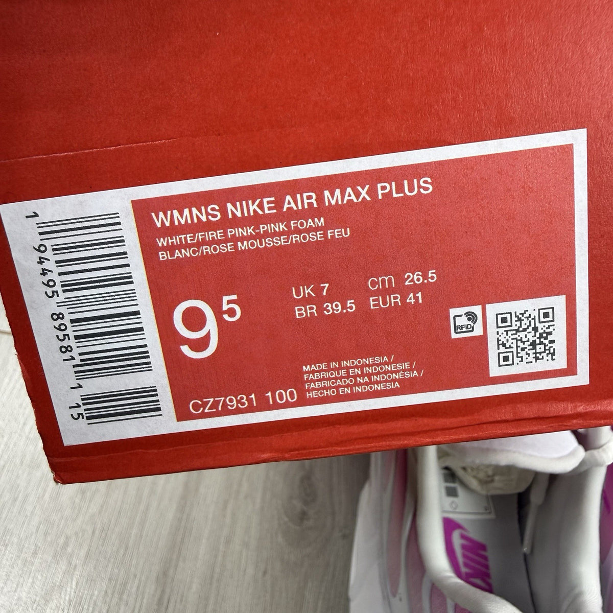 Nike Air Max Plus TN white trainers with pink fade and distinctive wavy design.