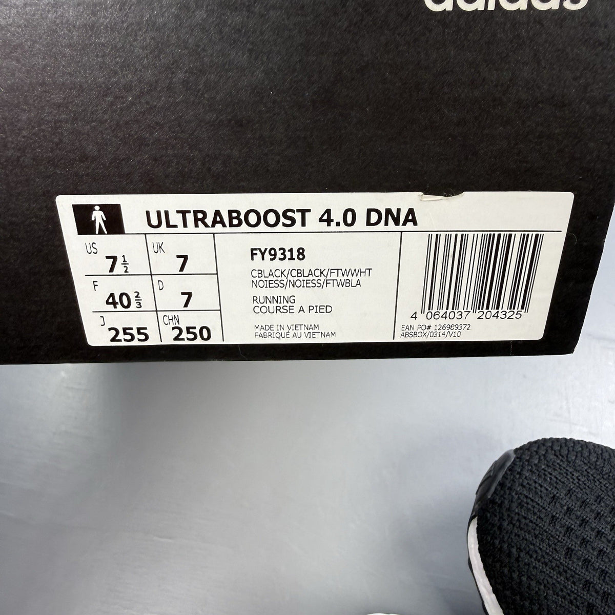 Adidas black Ultra Boost trainers with white accents and signature three-stripe logo.