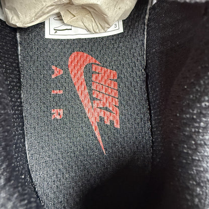 Nike TN Air Max Plus trainers black with red gradient and signature logo design.
