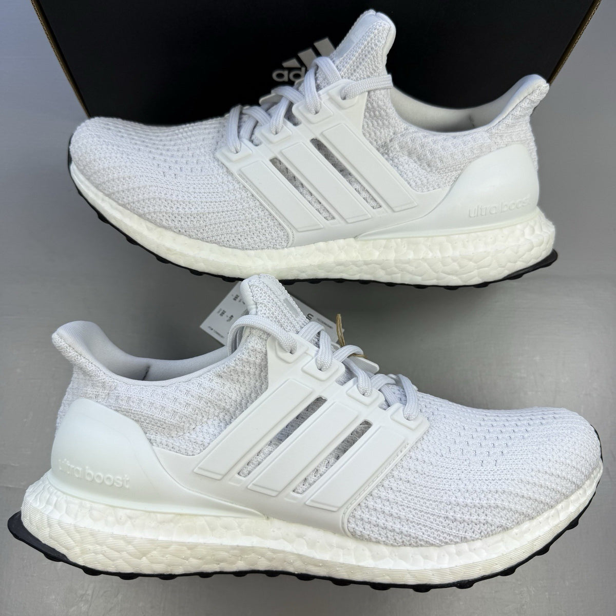Adidas men's sneakers white with black accents and signature three-stripe logo.
