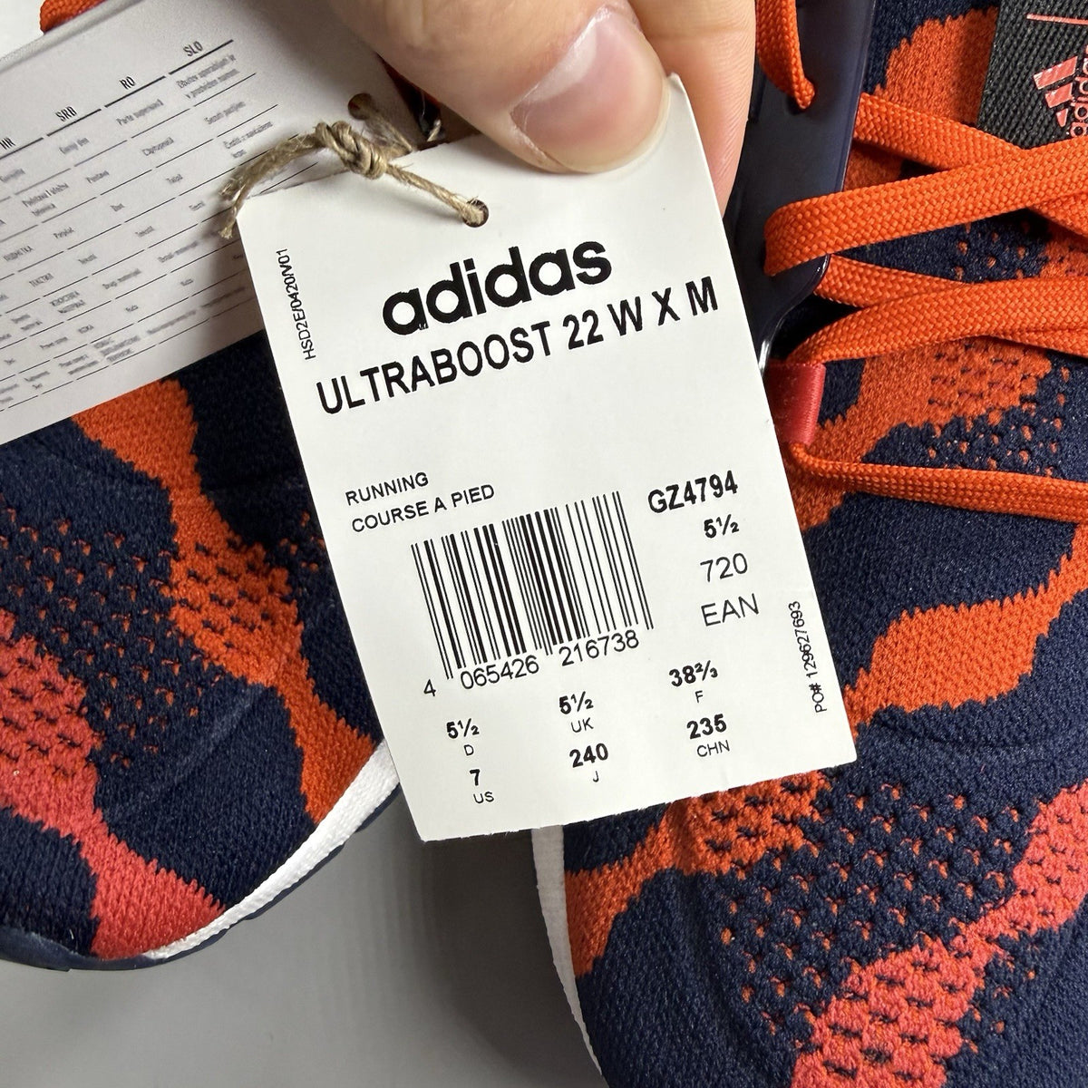 Adidas red Ultra Boost 22 trainers with Marimekko floral pattern and Parley branding.