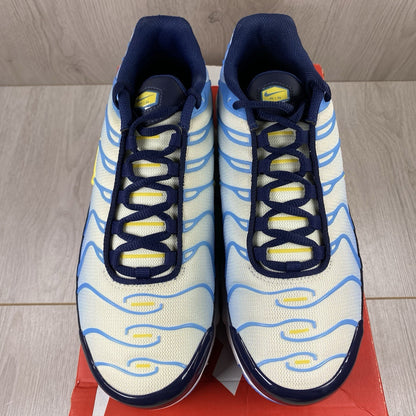 Nike Air Max Plus TN blue trainers with yellow accents and signature swoosh logo.