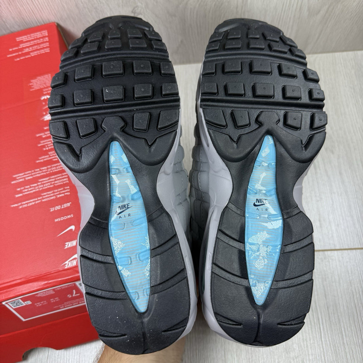 Nike Air Max 95 trainers grey with aqua blue accents and retro logo details.
