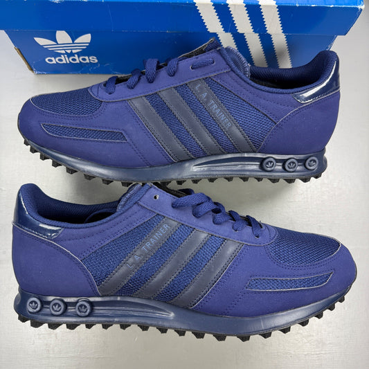 Adidas blue trainers with black accents and signature three-stripe logo.