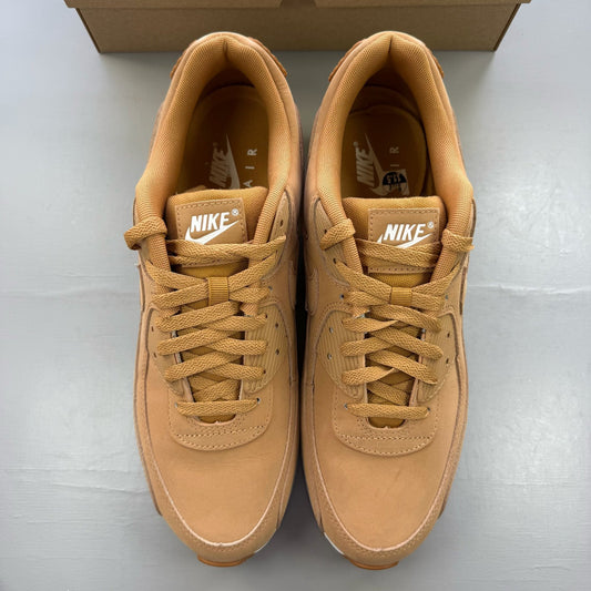Nike Air Max 90 brown trainers with premium suede material and iconic swoosh logo.