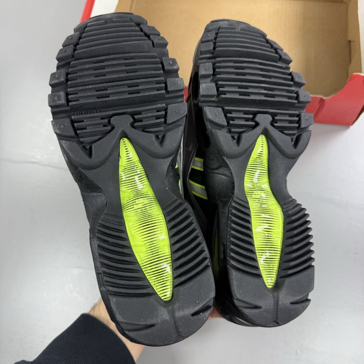 Nike NDSTRKT Air Max 95 black trainers with neon accents and textured material.