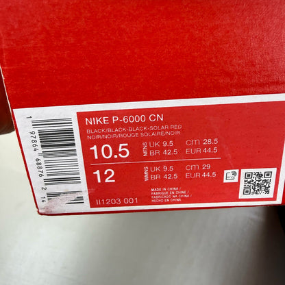 Nike black trainers with zebra pattern, solar red accents, and white detailing.