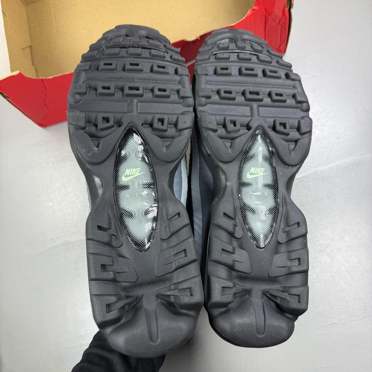 Nike running shoes black with mint foam accents and anthracite detailing.