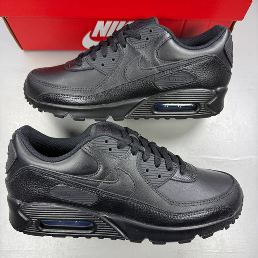 Nike athletic shoes black leather with Air Max branding and textured design.
