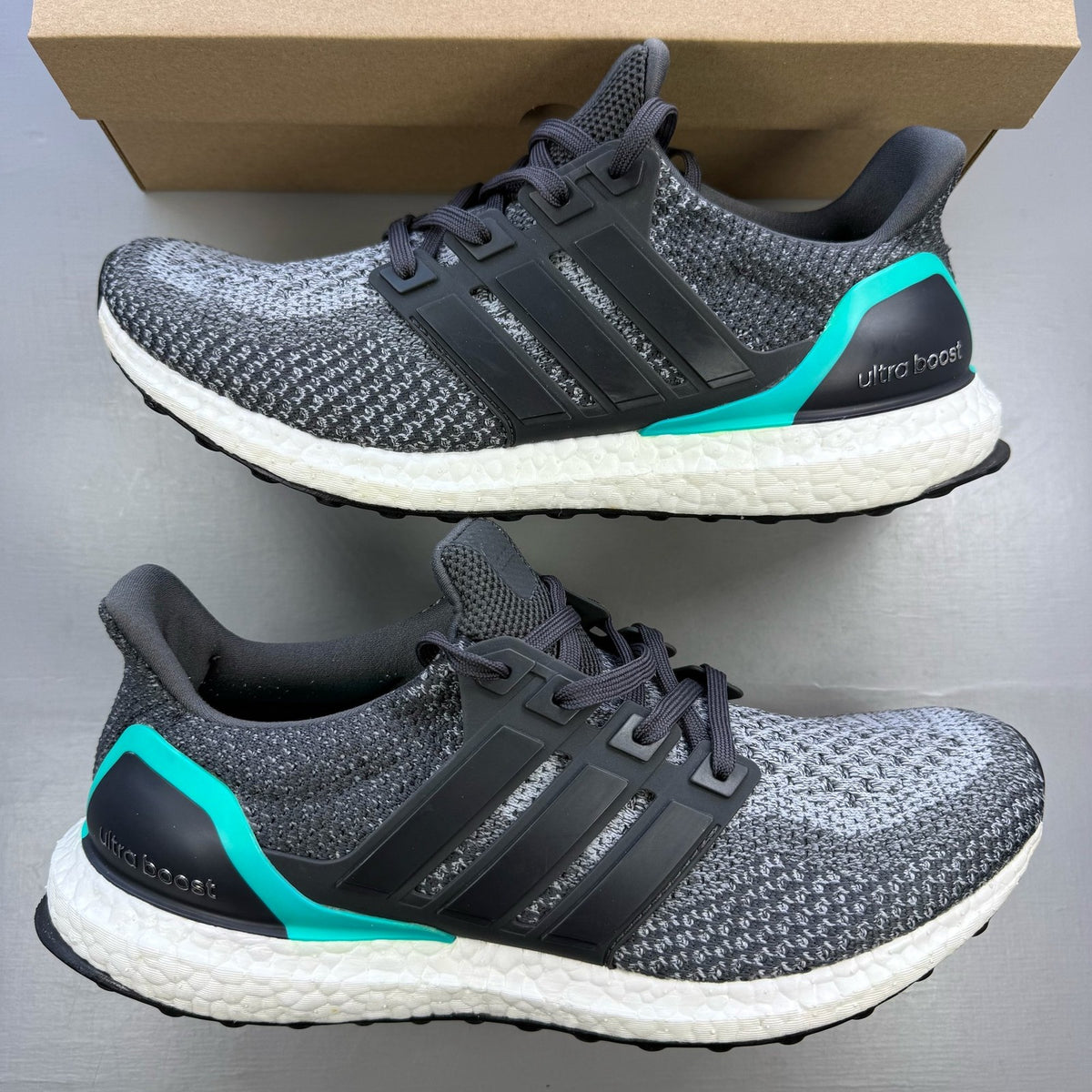 Adidas Ultra Boost 2.0 grey trainers with shock mint accents and logo detailing.