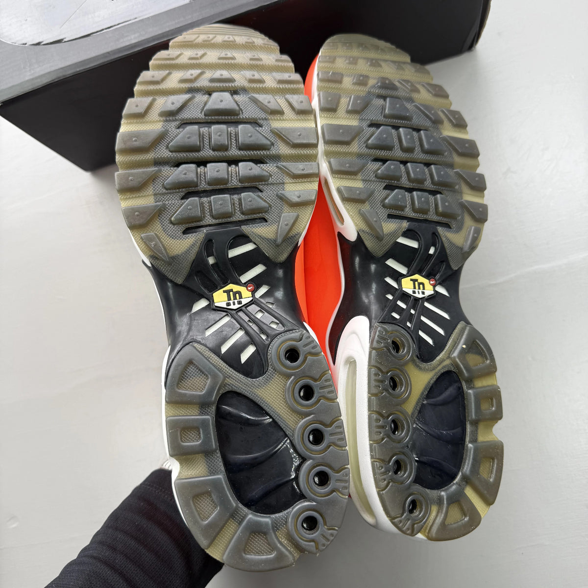 Nike Air Max Plus trainers total orange with large logo and mesh material.