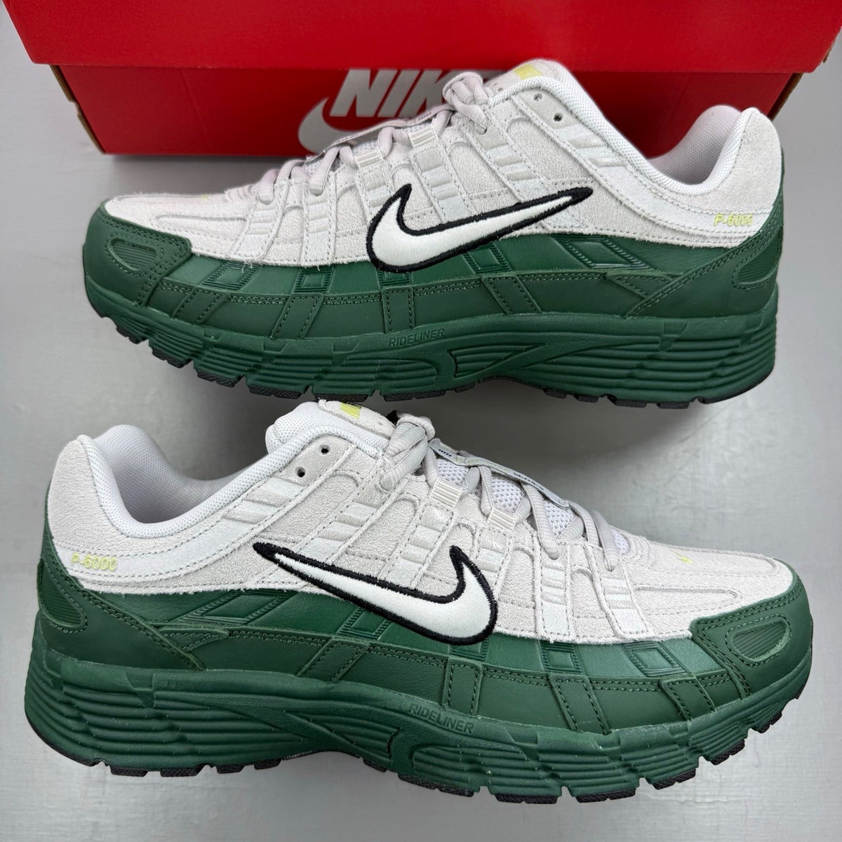 Nike P-6000 grey trainers with mesh upper and signature swoosh logo.