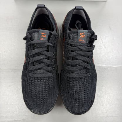 Nike Air VaporMax Flyknit 3 black trainers with total orange accents and breathable knit material.