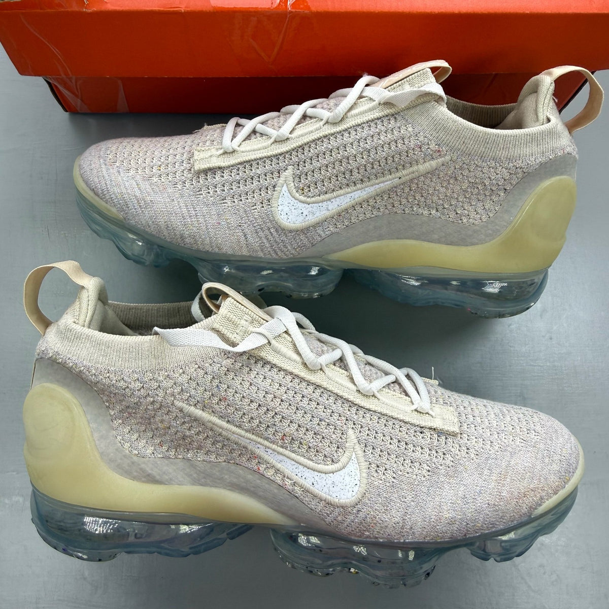 Nike Air VaporMax 2021 FK white trainers with breathable knit upper and signature swoosh logo.
