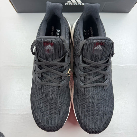 Adidas black Ultra Boost trainers with white accents and signature three-stripe logo.
