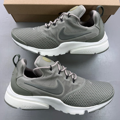 Nike trainers khaki green mesh upper with white sole and logo details.