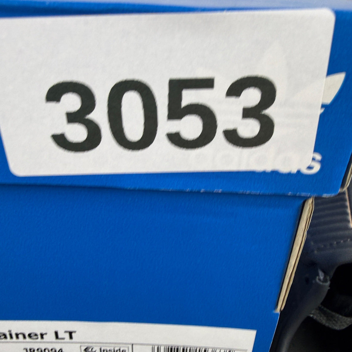Adidas black deck shoes with blue and white accents, featuring classic logo design.