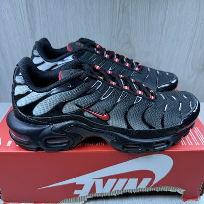 Nike TN Air Max Plus trainers black with red gradient and signature logo design.