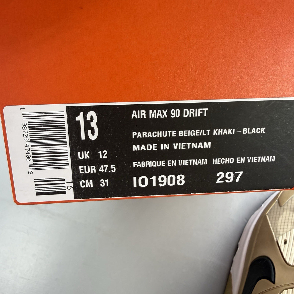Nike Air Max 90 Drift beige trainers with white accents and logo detailing.
