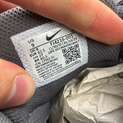 Nike Air Max 95 grey trainers with blue accents and visible logo detailing.
